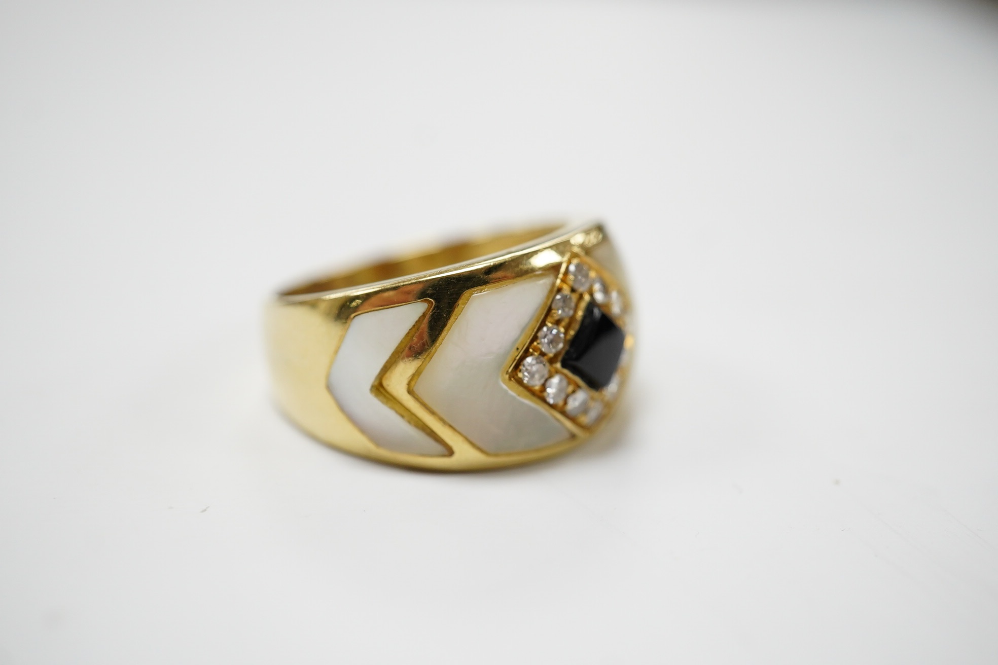 An Italian? yellow metal, mother of pearl, black enamel and diamond cluster set dress ring, size Q, gross weight 8.3 grams. Condition - fair